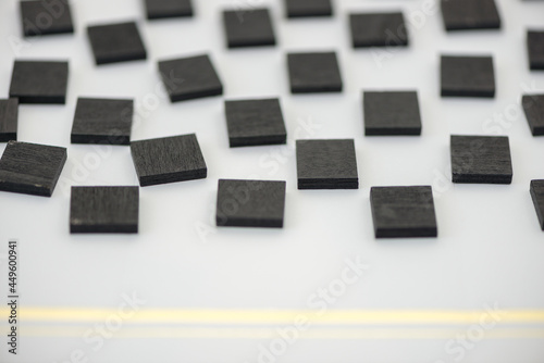 black chalk tiles arranged on white stationary paper