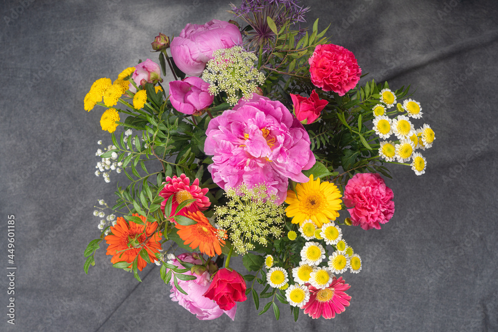 A large and beautiful bouquet with peonies, roses, view from the top, on a dark background. Congratulation concept. A large and beautiful bouquet with peonies, roses, view from the top, on a dark background. Congratulation concept.