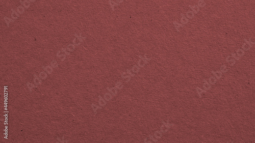The surface of dark brown cardboard. Paper texture with cellulose fibers. Paperboard wallpaper or background. Macro