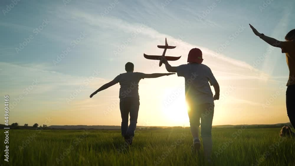 happy family. boy with airplane and family running at sunset silhouette in the park. dream of becoming a pilot concept. happy family silhouette running together in the park. travel childhood dream happy family. boy with airplane and family running at sunset silhouette in the park. dream of becoming a pilot concept. happy family silhouette running together in the park. travel childhood dream
