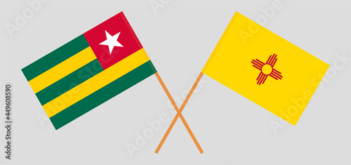 Crossed flags of Togo and the State of New Mexico. Official colors. Correct proportion.
