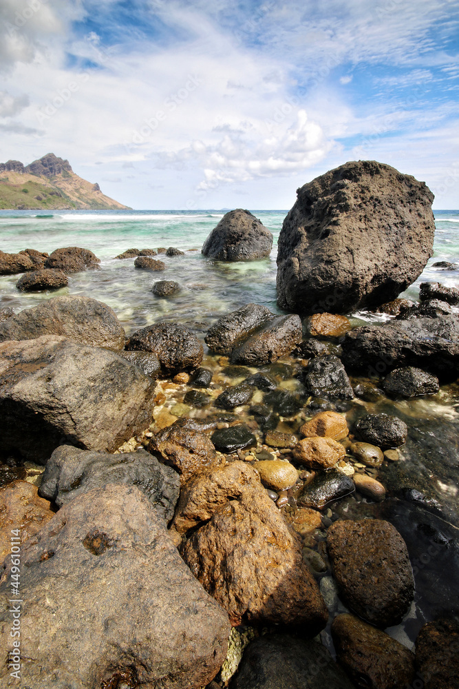 a close up of a rock next to a body of water