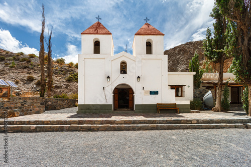 Facade of Iglesia San Cayetano with hills in the background in El Alfarcito, Salta, Argentina photo