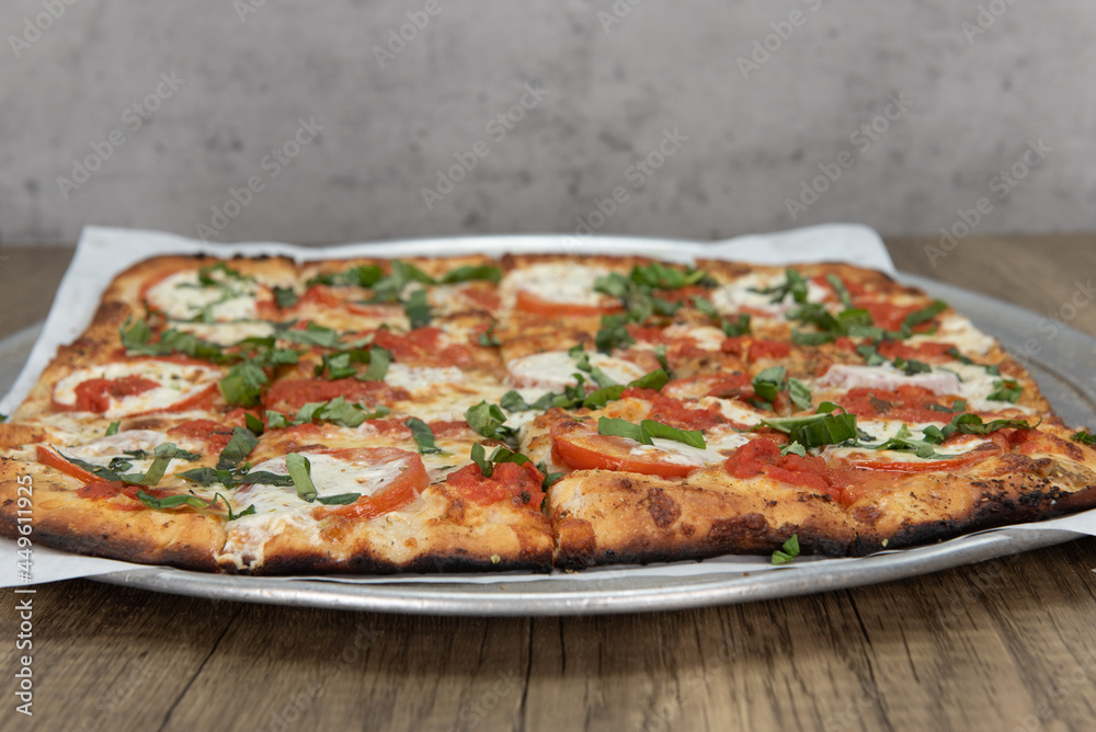 Margaritta pizza loaded with tomato toppings and a crispy crust for a full family meal