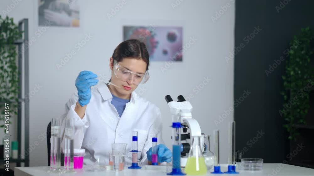 chemist student woman is doing laboratory test, examining and exploring samples of substances chemist student woman is doing laboratory test, examining and exploring samples of substances