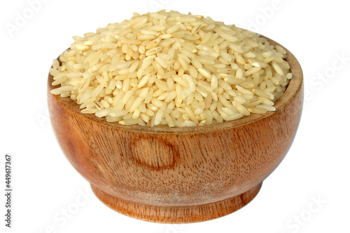 Dry rice in a wooden bowl  on a white background
