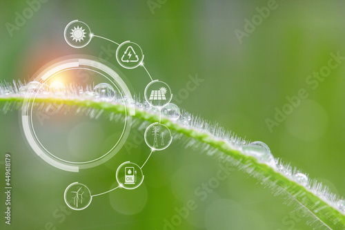 Power and environmental icons with water drop on green grass background. energy and environmental concept.