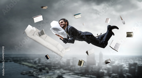 Joyful happe businessman levitating horizontally photo