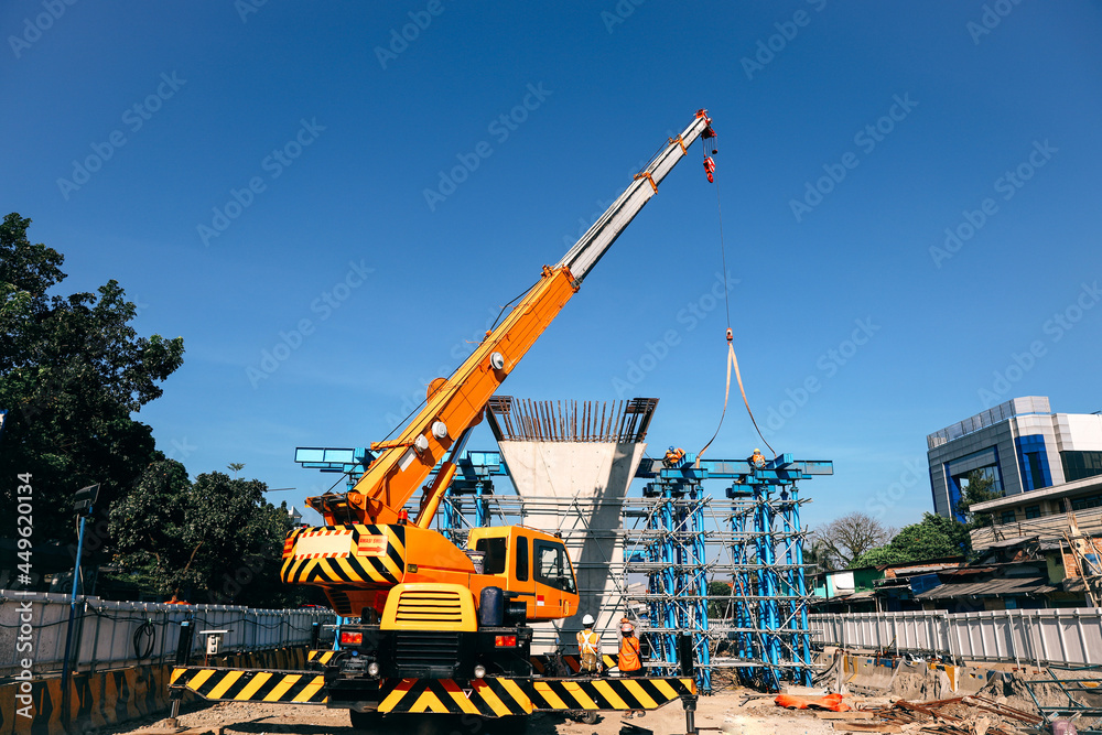 Industrial Crane lifting steel frame in mega construction site