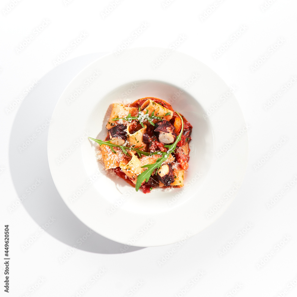 Cannelloni pasta with seafood and Parmesan cheese. Lasagna cannelloni pasta stuffed with tomato sauce and fried octopus. Italian pasta in white plate isolated on white background . Cannelloni pasta with seafood and Parmesan cheese. Lasagna cannelloni pasta stuffed with tomato sauce and fried octopus. Italian pasta in white plate isolated on white background .