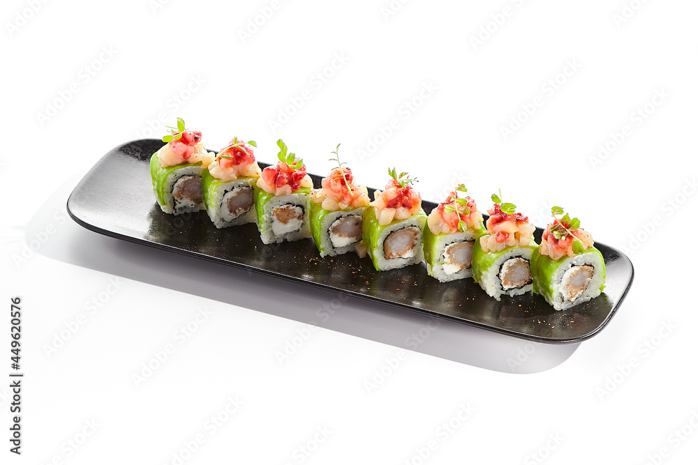 Shrimp Sushi Roll on black slate plate. Luxury maki sushi roll with cream cheese and shrimp inside. Seafood sushi roll topped with spicy scallop. Isolated on white background. Shrimp Sushi Roll on black slate plate. Luxury maki sushi roll with cream cheese and shrimp inside. Seafood sushi roll topped with spicy scallop. Isolated on white background.