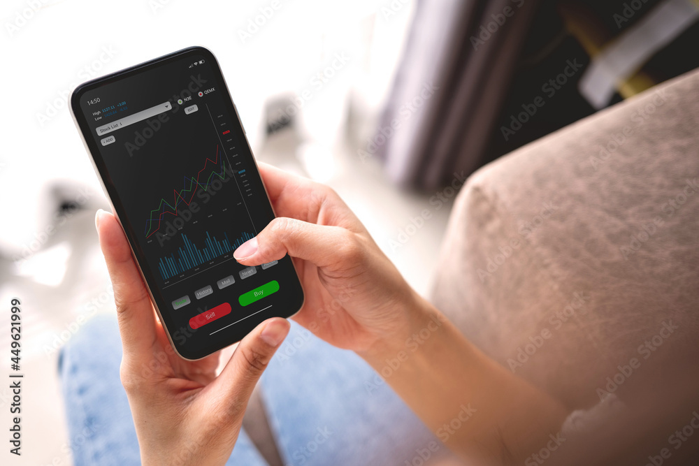 The younger generation is using laptops, phones and tablets with stock status information or stock charts. Stock trend chart graph analysis. Business concept