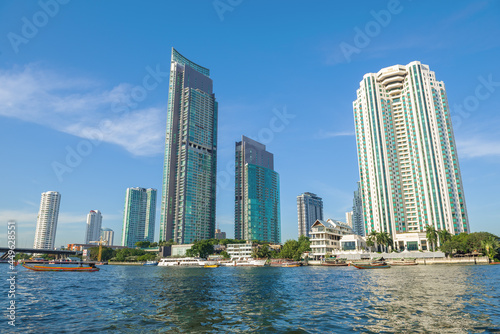Modern high-rise buildings on the banks of the Chao Phraya river on a sunny day. Bangkok  Thailand
