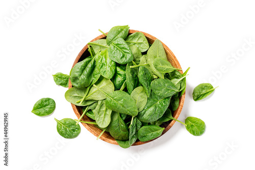 Fresh spinach leaves on wooden plate. Healthy vegan food. Top view. isolated on white background. photo