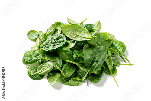 Pile of fresh green baby spinach leaves isolated on white background.