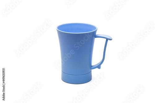 Blue old plastic tea mug close up on isolated white background