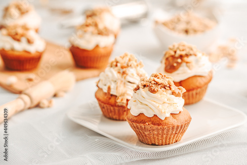 Muffin. Creme muffins with caramel and nuts. Creme on the top of muffin. Caramel muffins.  
