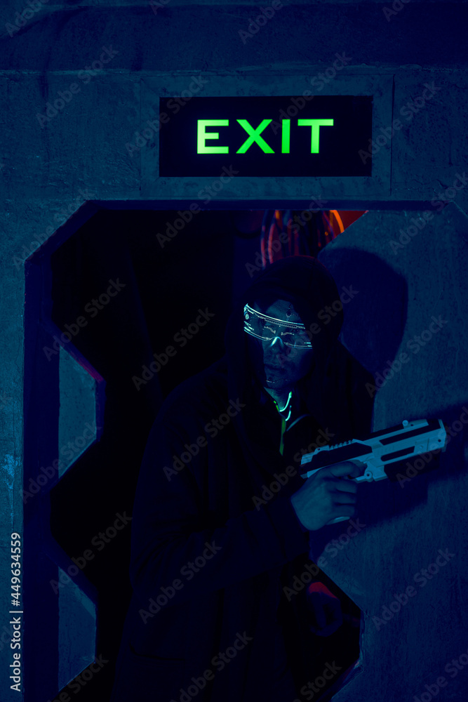 Man with blaster in the futuristic battle. Concept virtual reality, cyber game. Man with blaster in the futuristic battle. Concept virtual reality, cyber game.