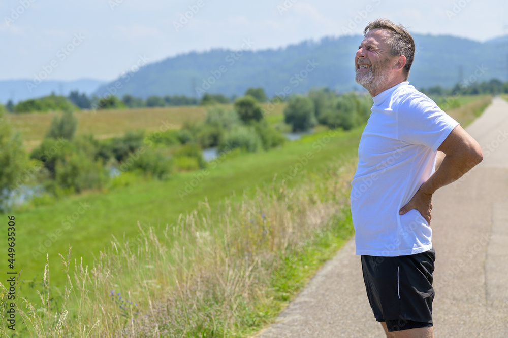 Middle-aged man suffering from acute back pain Middle-aged man suffering from acute back pain