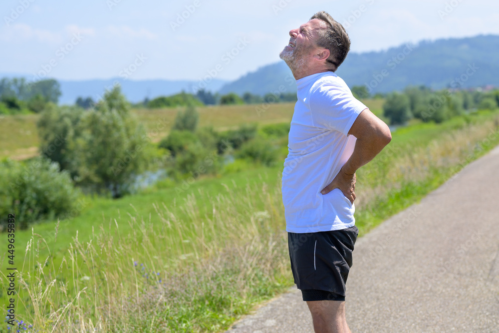 Middle-aged man suffering from acute back pain Middle-aged man suffering from acute back pain