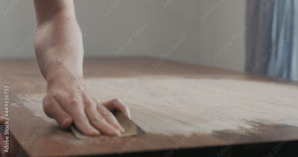 man hand sanding black walnut wood table man hand sanding black walnut wood table