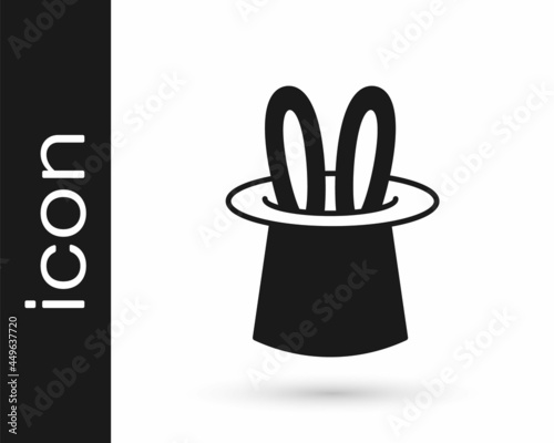 Black Magician hat and rabbit ears icon isolated on white background. Magic trick. Mystery entertainment concept. Vector