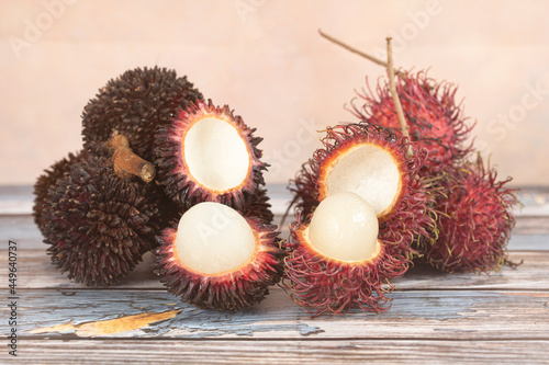 Rambutan and pulasan fruits side by side. Both belongs to the soapberry family. Selective focus points. Blurred background photo