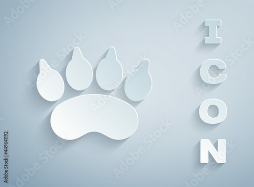 Paper cut Bear paw footprint icon isolated on grey background. Paper art style. Vector