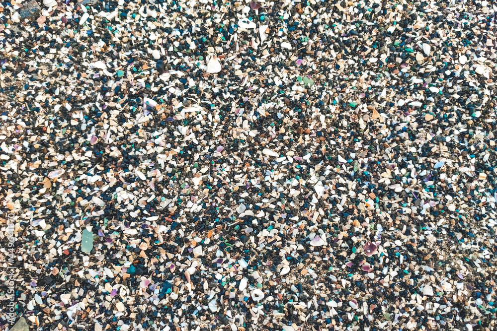 texture of pebbles and small seashells on the beach.