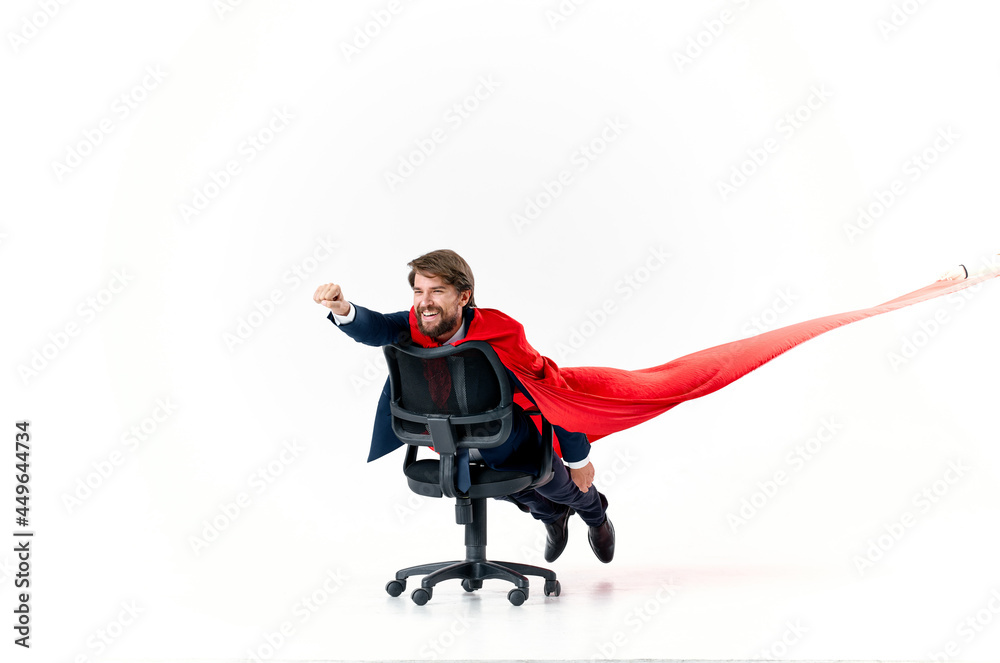 business man with red cloak trying in superman office chair
