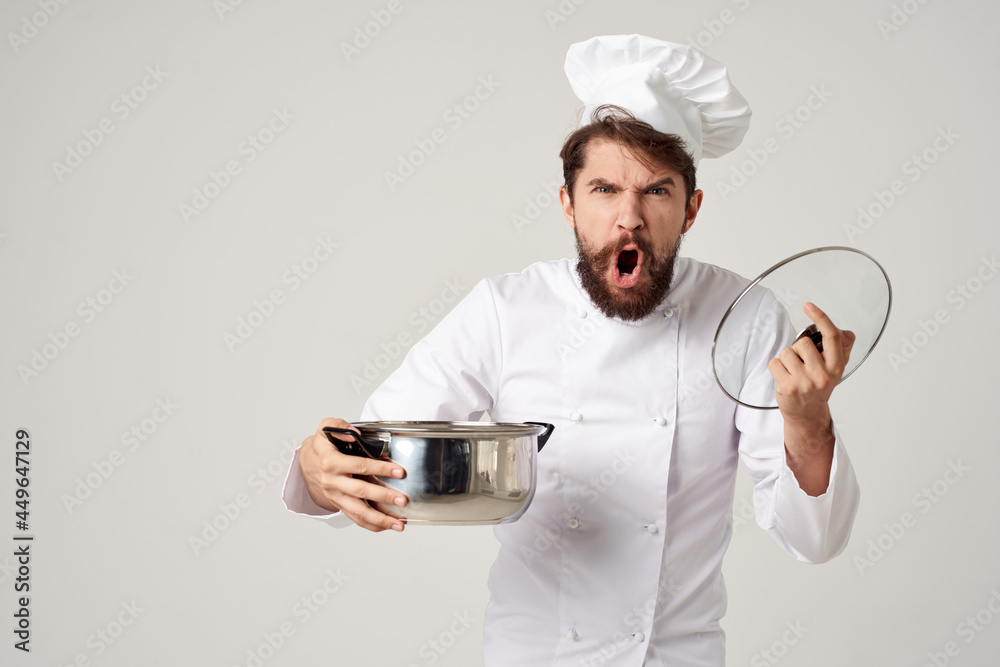 a man in a cook's uniform with a pan in his hands cooking restaurant industry