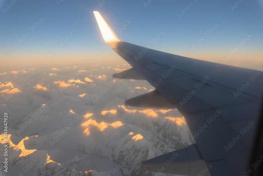 Twilight sky view from airplane window on the wing on sunset time.
Twilight sky view from airplane window on the wing on sunset time.