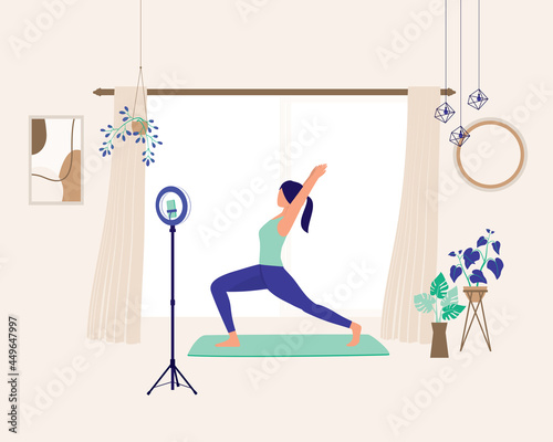 Side View Of A Young Woman Teaching Yoga On Live Streaming At Home. Online Fitness Class. Social Media Influencer And Vlogger.