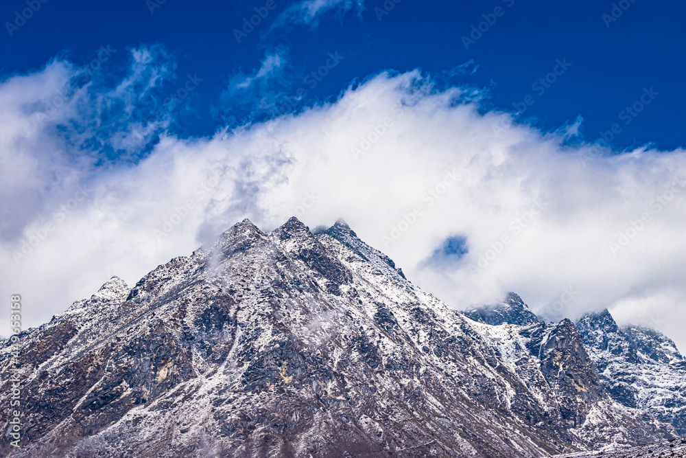 snow cap mountains with bright blue sky at morning from flat angle