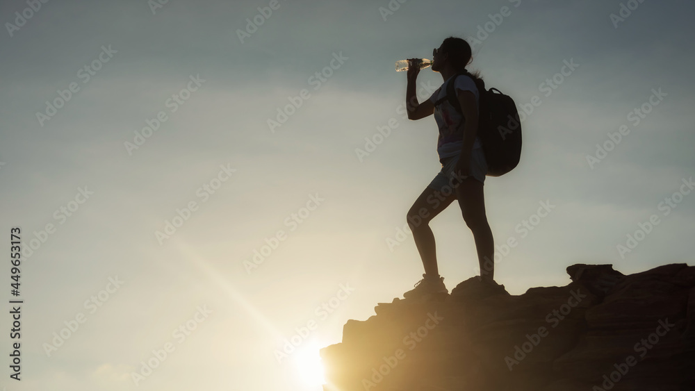 Climber drink water after reach hiking to summit