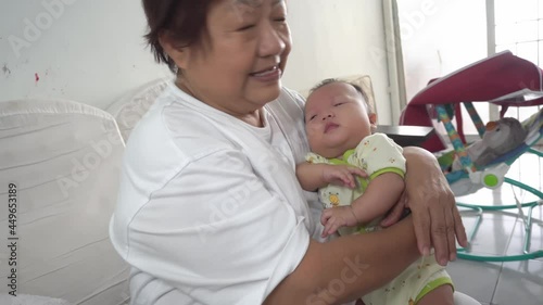 Grandmother burp baby boy after drink the milk