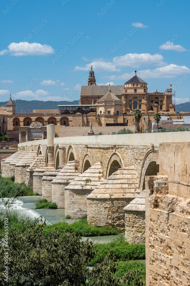 View of the Cordoba mosque next to the Roman bridge as it passes through the Guadalquivir