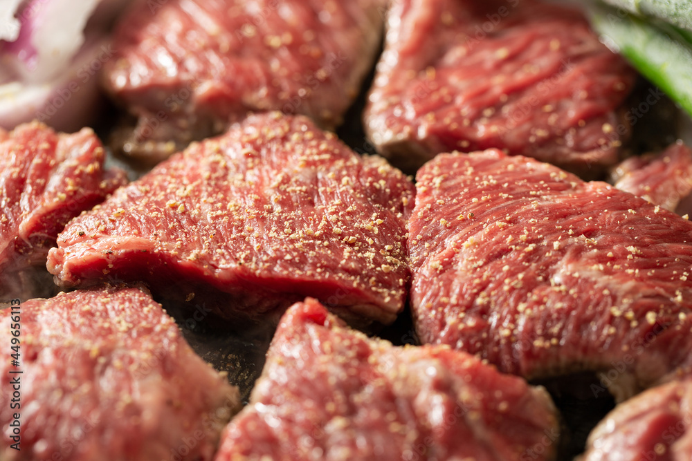 Seasoned raw meat and vegetables in a cast iron pan Seasoned raw meat and vegetables in a cast iron pan