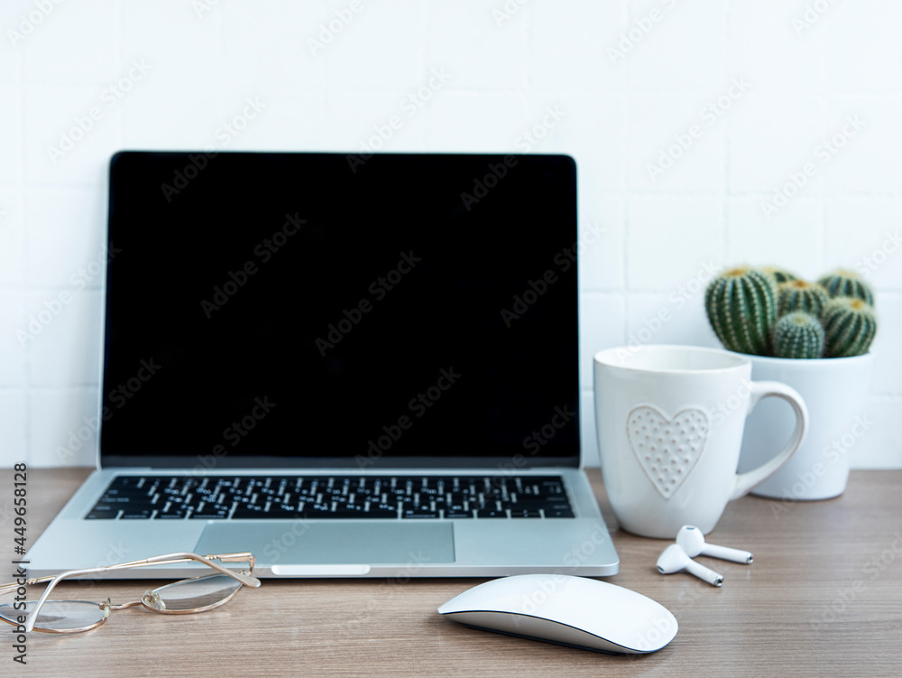 Laptop with office supplies on the table. Laptop with office supplies on the table.