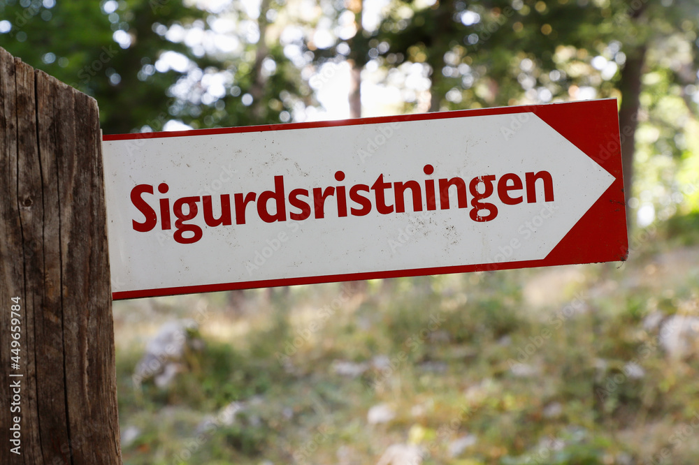Signpost with direction to the runic heritage rock carving Sigurdristningen near Eskilstuna in the Swedish province of Sodermanland.