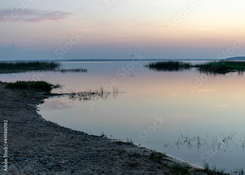 summer landscape on the shore of the lake at dawn  colors in the sky before sunrise  Lake Burtnieki  Latvia