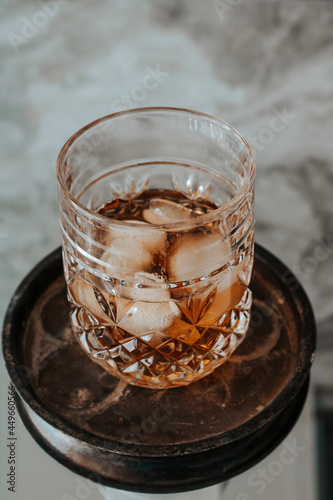  Glass of whisky from old wooden cask at the dark background.