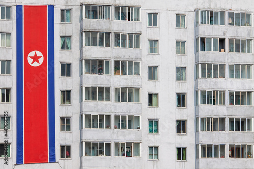 The North Korean national flag displayed vertically against a wall