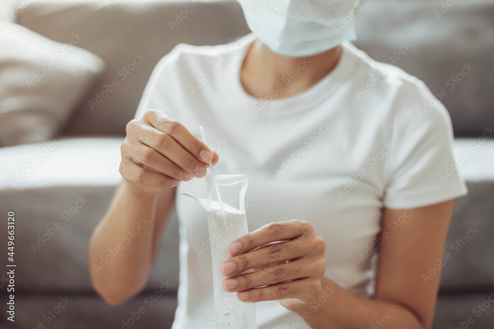 Woman self test for COVID-19 home test kit. asian woman using coronavirus covid-19 rapid antigen home testing kit, Coronavirus nasal swab test for infection. Woman self test for COVID-19 home test kit. asian woman using coronavirus covid-19 rapid antigen home testing kit, Coronavirus nasal swab test for infection.