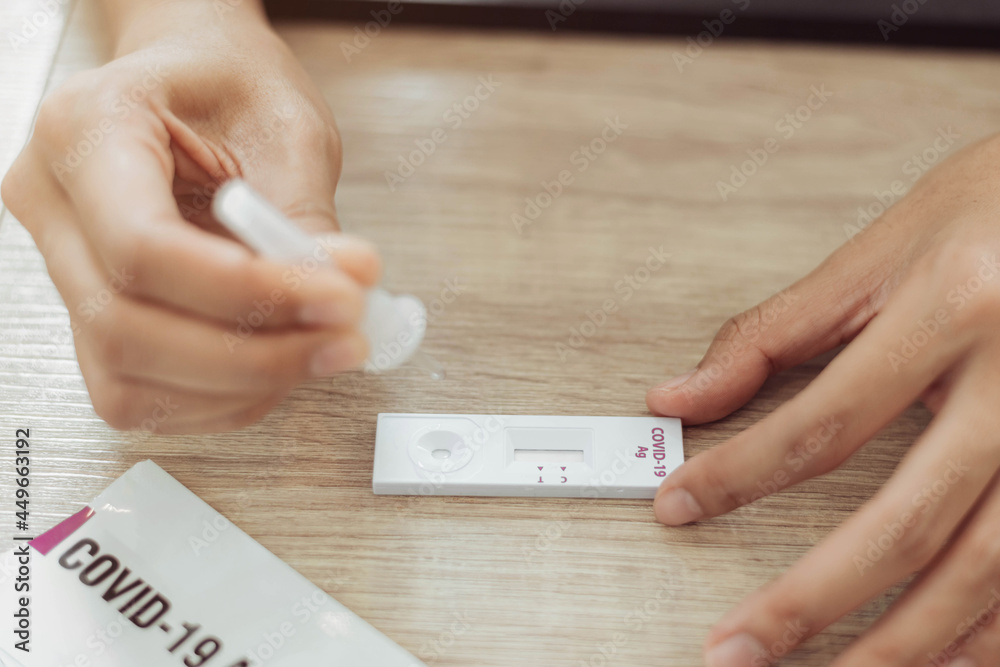 Woman self test for COVID19 home test kit. asian woman using coronavirus covid19 rapid antigen