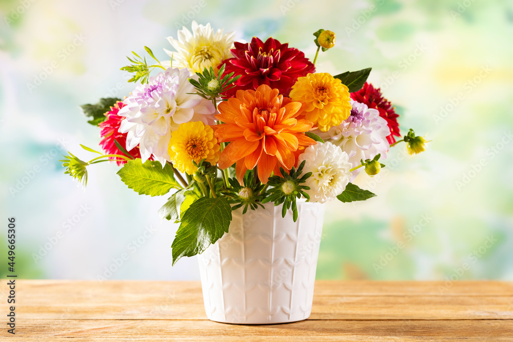 Autumn still life with garden flowers. Beautiful autumnal bouquet in vase  on wooden table. Colorful dahlia and chrysanthemum. Photos | Adobe Stock