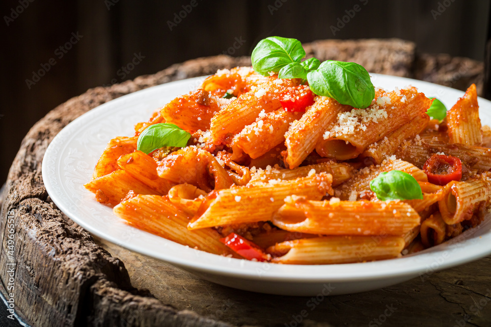 Spicy penne bolognese with parmesan. Italian cuisine. Spicy penne bolognese with parmesan. Italian cuisine.