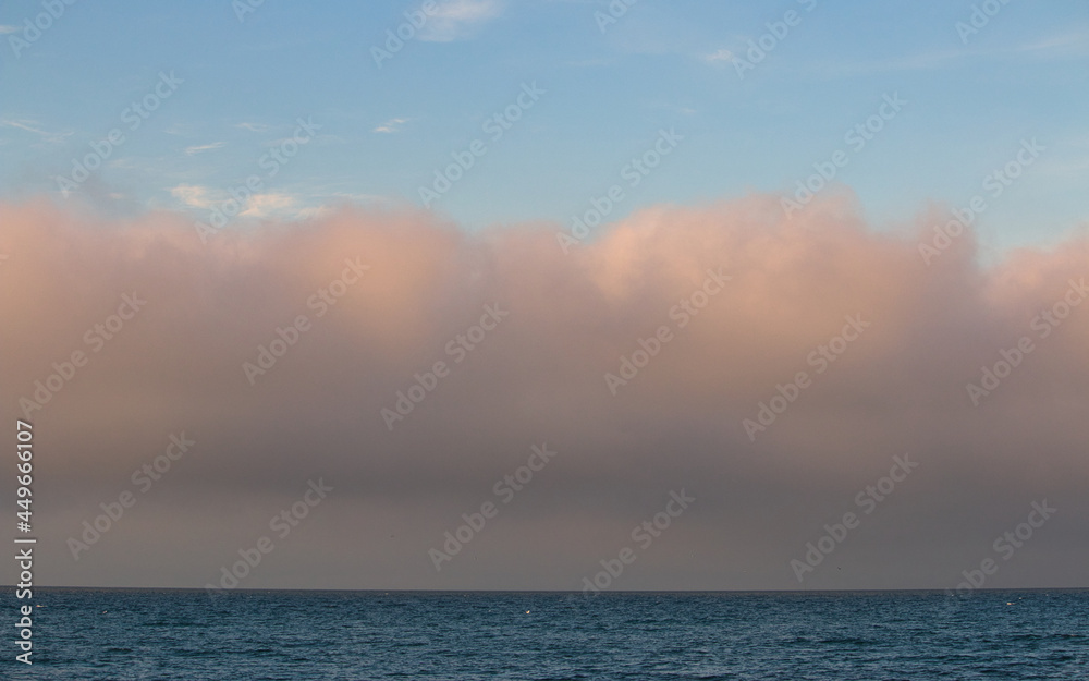 A fog bank at sea at sunset