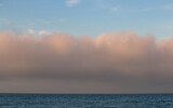A fog bank at sea at sunset