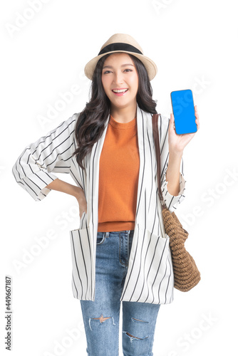 traveller adult attractive cheerful smiling asian female wear casual cloth with hat and pursehand use smartphone ready to travel in summer time vacation ideas concept isolate white background